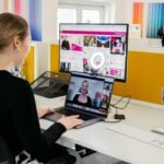 a woman sitting at a desk with a laptop computer